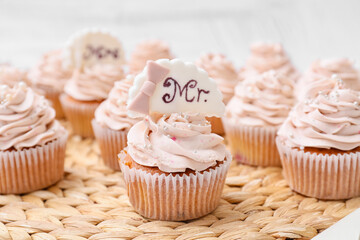 Tasty wedding cupcakes on wicker mat