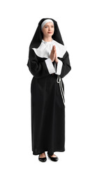 Young praying nun on white background