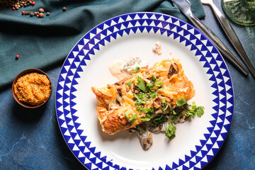Plate with piece of delicious casserole with minced meat on dark background