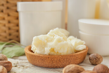 Bowl of shea butter on wooden table