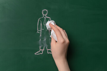 Woman wiping off drawn human figure on color background. Concept of dismissal