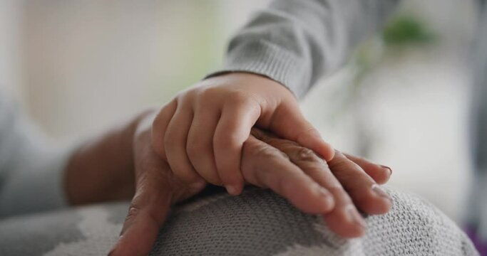 little girl holding hands with grandmother child showing compassion for granny enjoying love from granddaughter family support concept unrecognizable people 4k
