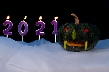 Pumpkin and number candles Halloween concept 2021