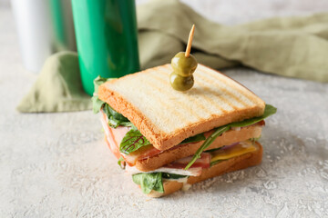 Fototapeta na wymiar Tasty sandwich and cans of soda on table, closeup