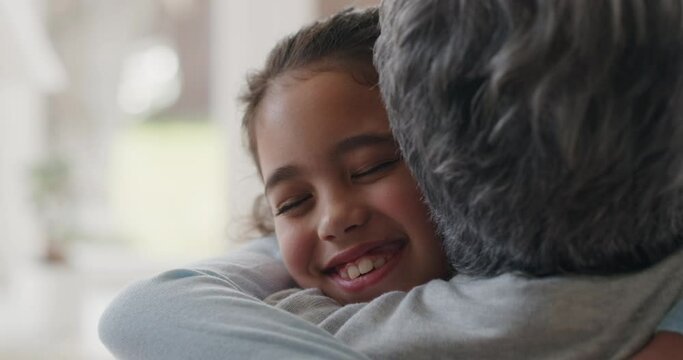 happy girl greeting grandmother with hug granny smiling embracing her granddaughter enjoying hug from grandchild at home family concept 4k