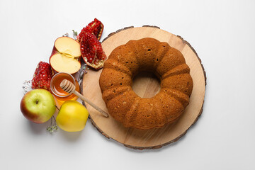 Bread with honey, pomegranate and apples on white background. Rosh hashanah (Jewish New Year) celebration