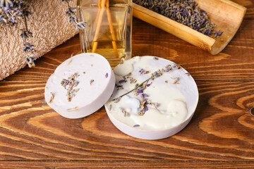 Soap bars and lavender flowers on wooden background