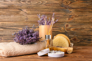 Composition with bath supplies and lavender flowers on wooden background