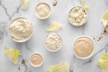 Composition with tasty Caesar sauce on white marble background