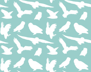 Vector seamless pattern of hand drawn owl silhouette isolated on mint background