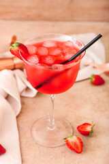 Glass of tasty cosmopolitan cocktail on color background