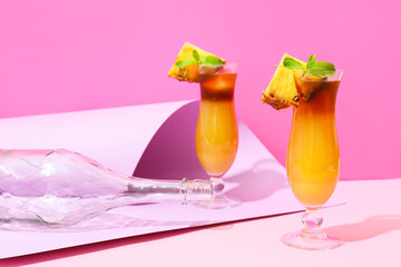 Glasses of tasty mai tai cocktail on color background