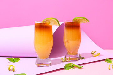 Glasses of tasty mai tai cocktail on color background