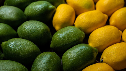Fresh lime and lemons background on market counter. Organic lemon on supermarket