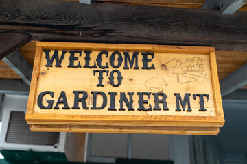 Wooden sign - Welcome to Gardiner Montana, a gateway town to Yellowstone National Park