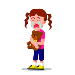 little girl crying while holding a teddy bear