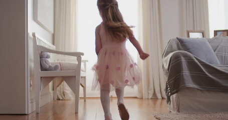 beautiful little girl dancing playfully pretending to be ballerina happy child having fun playing dress up wearing ballet costume with fairy wings at home 4k - Powered by Adobe