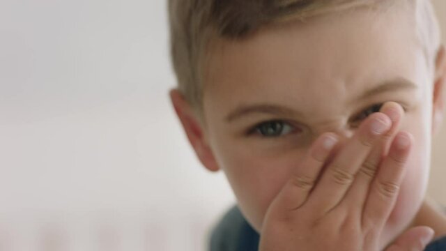 portrait happy little boy wiping nose looking at camera child with flu 4k footage