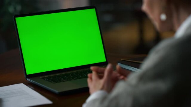 Unrecognizable elderly woman having web conference at mockup computer at home