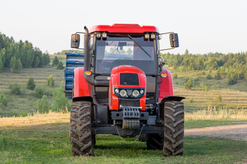Red new wheeled tractor of medium size.