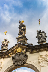 Fototapeta na wymiar Statues on the entrance gate of the Strahov Monastery in Prague, Czech Republic