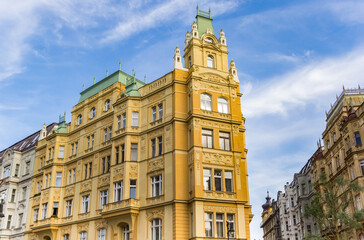Fototapeta premium Historic yellow apartment building in Prague, Czech Republic
