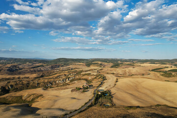 Fototapeta na wymiar Beautiful idyllic late summer landscape of Toscana with photographed with drone. Sunny day in Italy. Vacation, recreation mood. Agricultural fields of Tuscany 