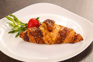 Sweet croissant in the plate