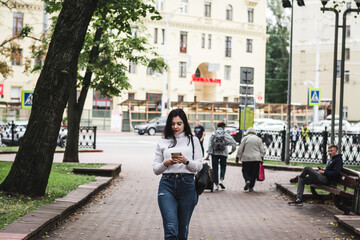 Stylish beautiful brunette girl in a summer city