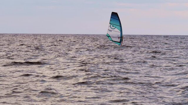 Windsurfer in the Waves with a Slightly Rough Sea - slow motion.