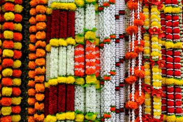Many various colours flowers abstract pattern backgrounds, artificial flowers and garlands at shop...