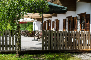 Austrian mountain restaurant with beergarden and wooden fence