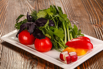 Fresh vegetables plate with vegetables and herbs