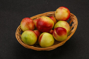 Sweet small nectarines in the basket