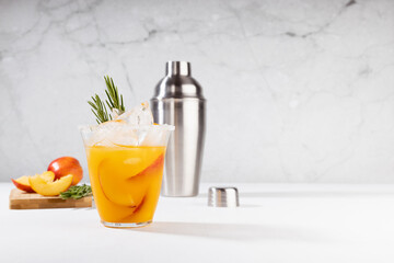 Cooking of homemade vitamin summer fresh orange peach lemonade with ice, green rosemary twig, sugar...