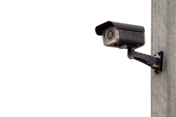 CCTV old weathered security camera mounted on a stone wall. White isolated background. Copy space. Outdoor surveillance equipment