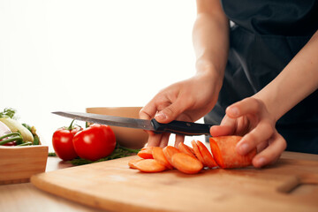 slicing carrots on a cutting board kitchen cooking vegetarianism