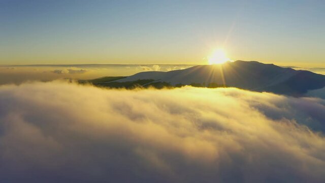 Wonderful view of extraordinary cloudy valley and bright orange sunset
