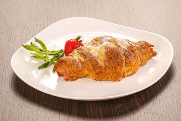 Sweet croissant in the plate