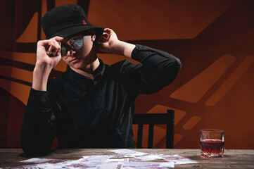 A cool man in round glasses at the money table