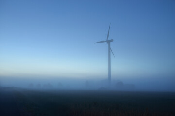 Wind turbine generator in a fog. Concept image, graphic resources, ecology, alternative energy and...