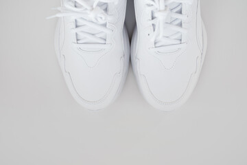 white sneakers with laces on a white background. isolate. top view.