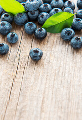 Blueberries on vintage wooden brown background