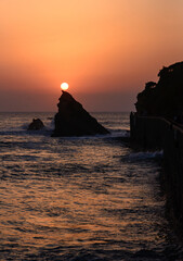 Magnificent sunset on the immersed rock of the Biarritz coast in the Basque Country