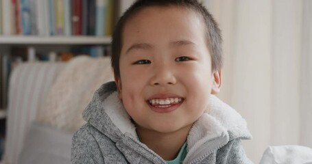 portrait funny little asian boy smiling looking at camera with naughty happy playful expression enjoying childhood testimonial concept 4k footage