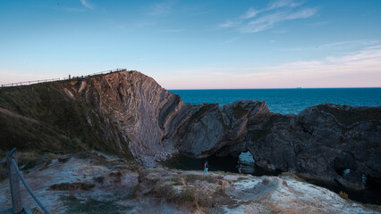 Rocky Coast Overlooking The Sunset At Lulworth Cove Dorset