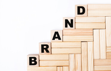 On a light background, wooden blocks and cubes with the text BRAND