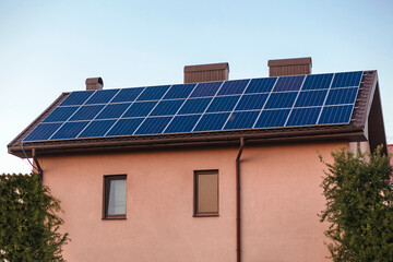 Fototapeta premium Private house with solar panels on the roof. 