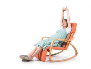 Young asian pregnant woman stretch oneself in modern rocking chair isolated on white.