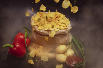 Potato chips, delicious spices, deep fried, thinly sliced, fast food. Paprika. Potatoes. Ketchup. Green onions.